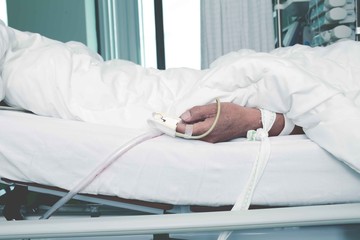 Patient tied to a bed in the critical care unit