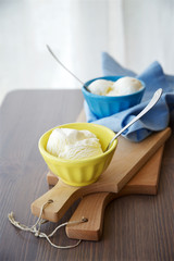 Vanilla ice cream in a bright cups 
