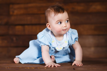 Cute little girl on a wooden background.