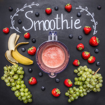 Smoothie ingredients on white wooden background, top view, border. Superfoods and health or detox diet food concept strawberries, bananas, white grapes, blueberries