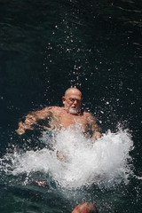 A swimmer splashing and kicking his feet in the sea