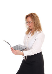 Business woman standing and working with laptop.