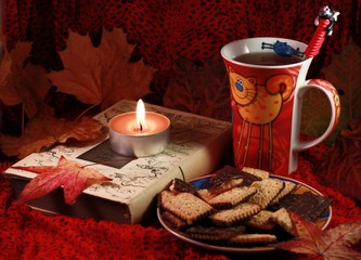 Autumn still life with tea leaves and candle