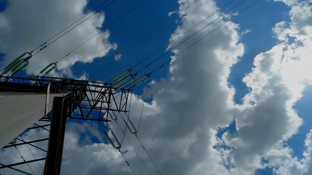 High-voltage tower sky timelapse Electricity pylons with long cable at day time