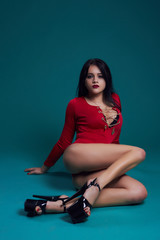 An attractive girl with a good figure is dancing of a seductive dance