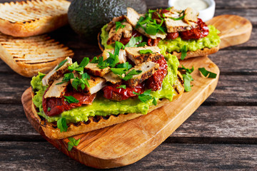 Avocado Sandwich with sunshine dried tomatoes, roasted pork and sauce herbs