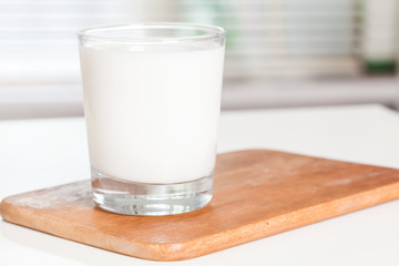 A glass of milk on an office desk. Selective focus.