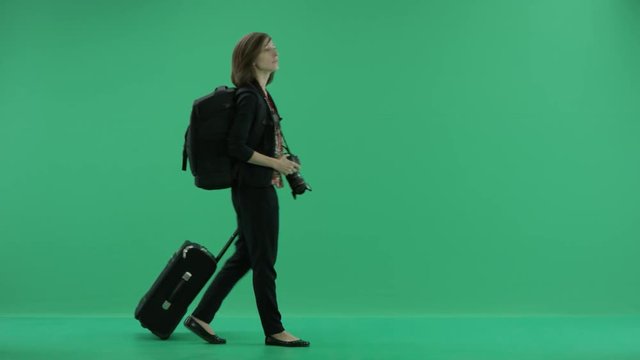 female tourist with camera walks looking around