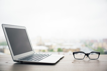 Blank laptop on bright background