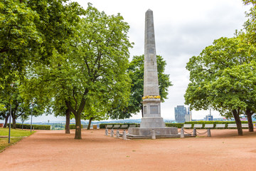 City park with benches. Obelisk in Denisovi sady.