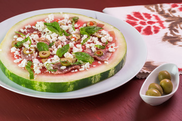 Watermelon pizza with crumbled feta cheese and prosciutto.