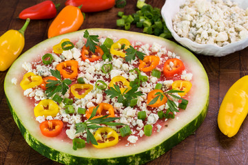 Vegetarian watermelon pizza with crumbled blue cheese, bell peppers and parsley.