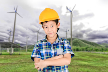 Asian boy wearing yellow hat with background green grass and tur