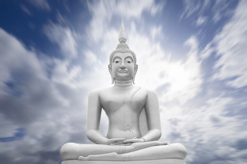 Fototapeta na wymiar white image of Buddha with blue sky and cloud in background, light effect added,filtered image,radial blurred sky,moving cloud , prachuapkhirikhan,thailand