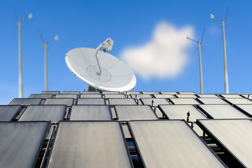 Solar panels, antenna booster and wind turbine against blue sky