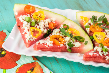 Pieces of vegetarian watermelon pizza with crumbled blue cheese,