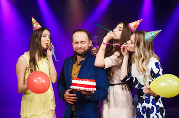 Happy birthday! Group of smiling friends gathered together with