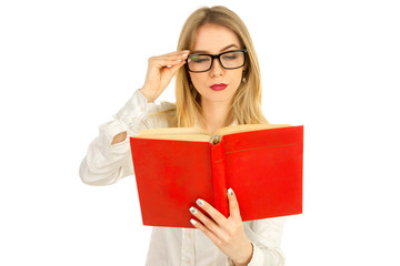 girl in glasses and a white shirt reading a book