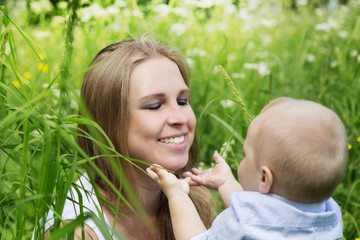 Happy mother with her son in a meadow