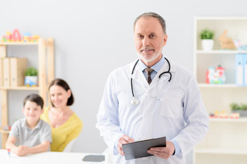 Little boy with his mother at doctor on consultation