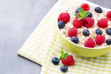 Oatmeal porridge with berries. Raspberries and blueberries.