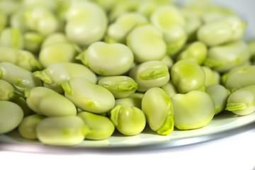 Green fresh broad beans in a plate