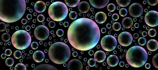 Rainbow bubbles on black - Randomly placed  different sized rainbow colored bubbles on a wide black background