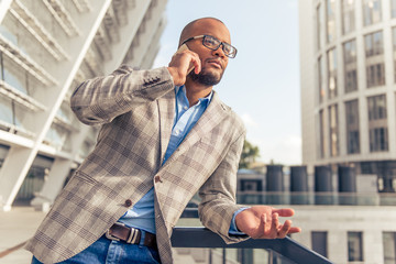 Afro American businessman with gadget