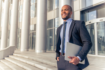 Afro American businessman with gadget