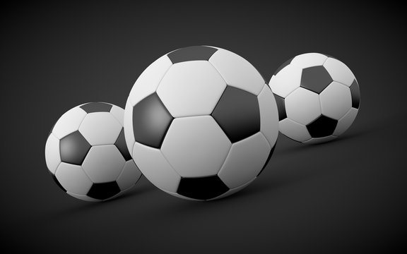 3D rendered soccer balls on black background.