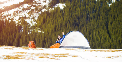 Climber with a backpack near the tent.