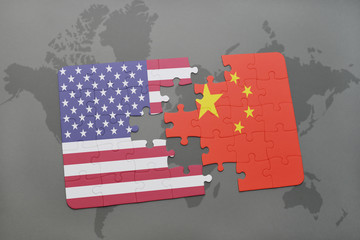 puzzle with the national flag of united states of america and china on a world map background