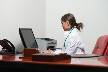 Successful Woman Doctor Working At Computer