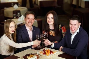 Friends at a restaurant drinking wine.