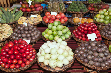 Fresh ripe exotic tropical fruits on shelves in Mercado dos Lavradores, Funchal, Madeira island, Portugal.