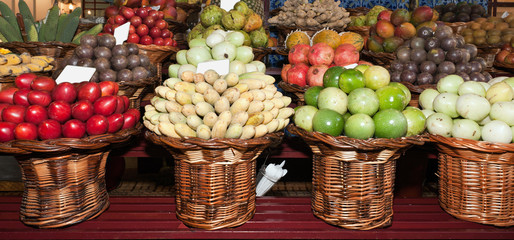 Fresh ripe exotic tropical fruits on shelves in Mercado dos Lavradores, Funchal, Madeira island, Portugal.