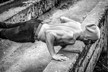 Slim fit man doing outdoor push ups