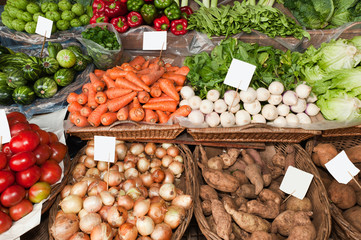 Fresh ripe vegetables on shelves in Mercado dos Lavradores, Funchal, Madeira island, Portugal.