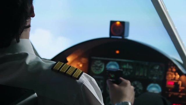 Male pilot flying in autopilot mode, transmitting information by walkie-talkie