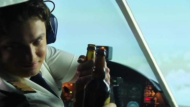 Insane captain of airliner drinking beer with co-pilot in cockpit, danger