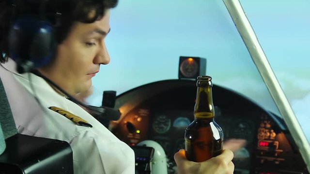 Crazy stewardess offering bottle of beer to captain, pilot refusing to drink