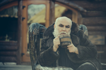 bearded cook with wooden cup