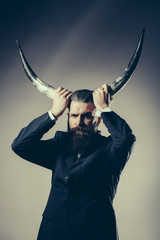 Bearded handsome man with antlers