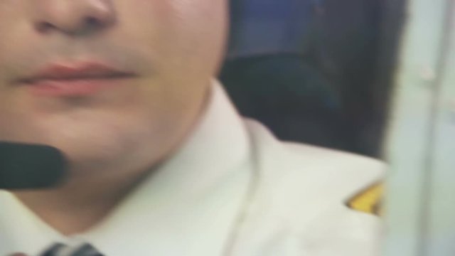 Tired pilot in headset navigating commercial plane, responsibility, commitment