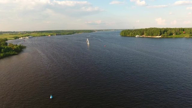 Sailing boat on the lake, the beautiful landscape, sky, clouds.Aerial view:Yacht on the surface of the lake on a sunny day.