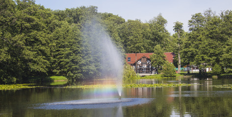 beautiful fountain and rainbow on a lake