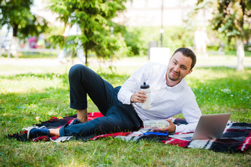 Businessman working in the garden and eating lunch