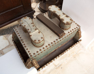 A rustic old antique leather shoe shine box.