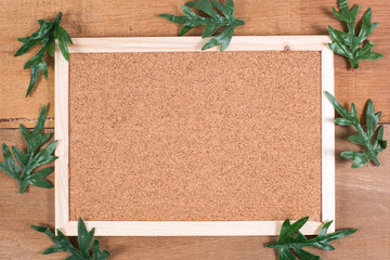 The cork board on the plank wood with the fake pine