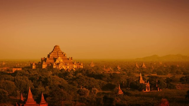 Video 3840x2160 - Landscape in Bagan, Myanmar, with the spires of ancient, Buddhist temple structures at sunset